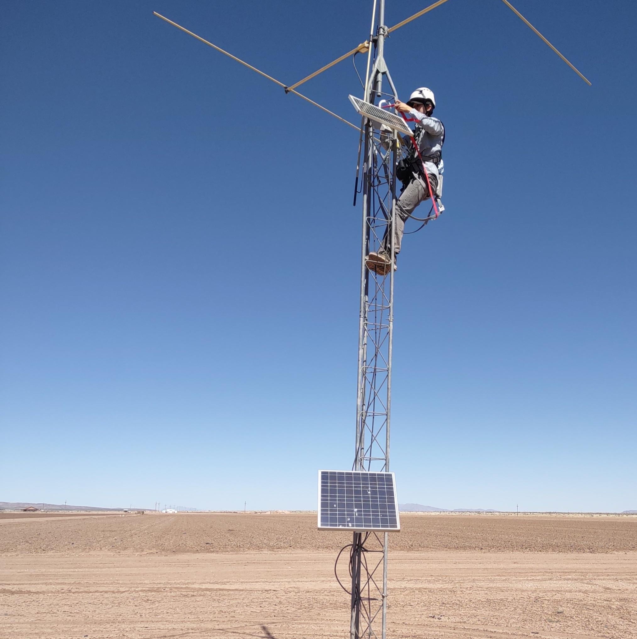 Student climbing a weather tower