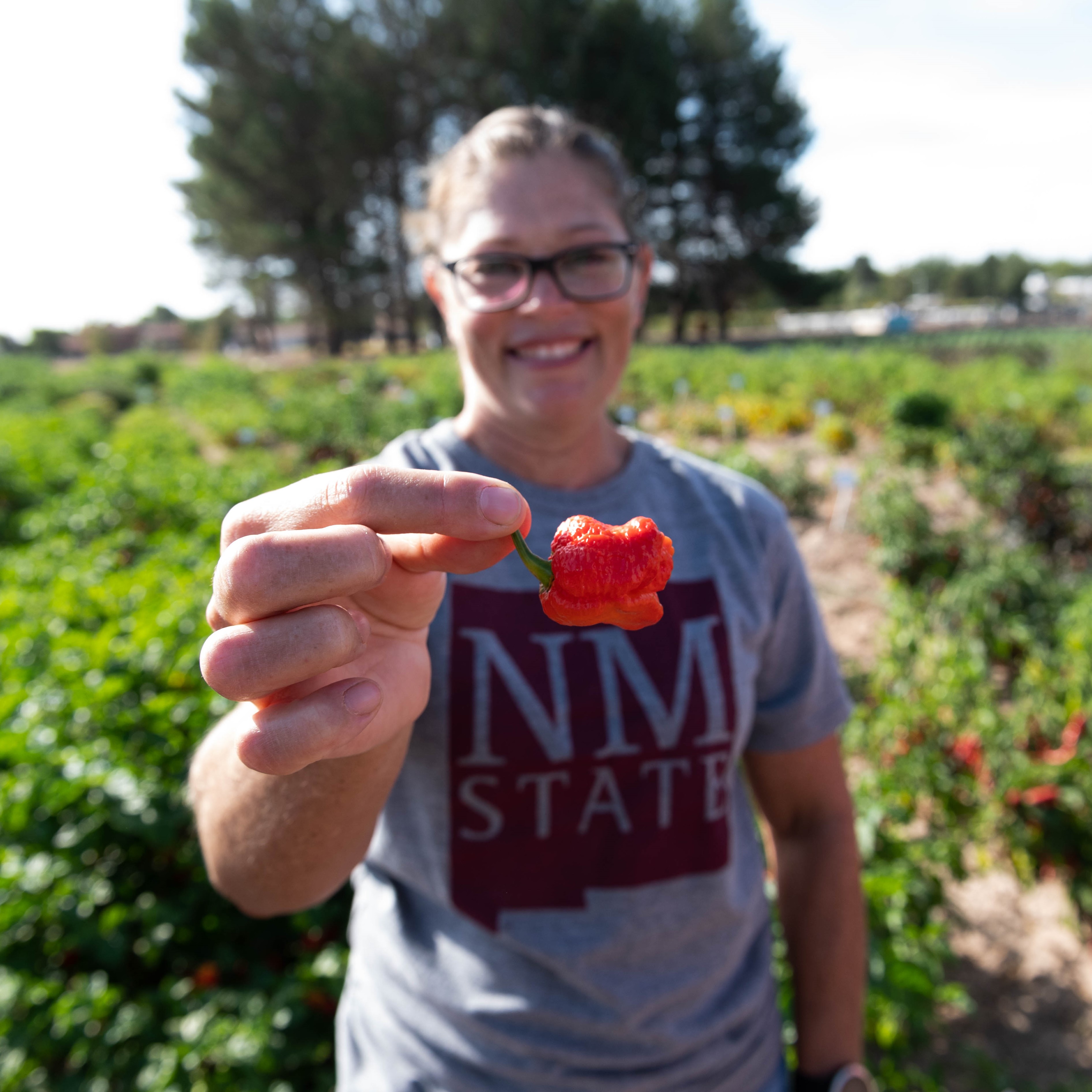 Woman holding a chile pepper