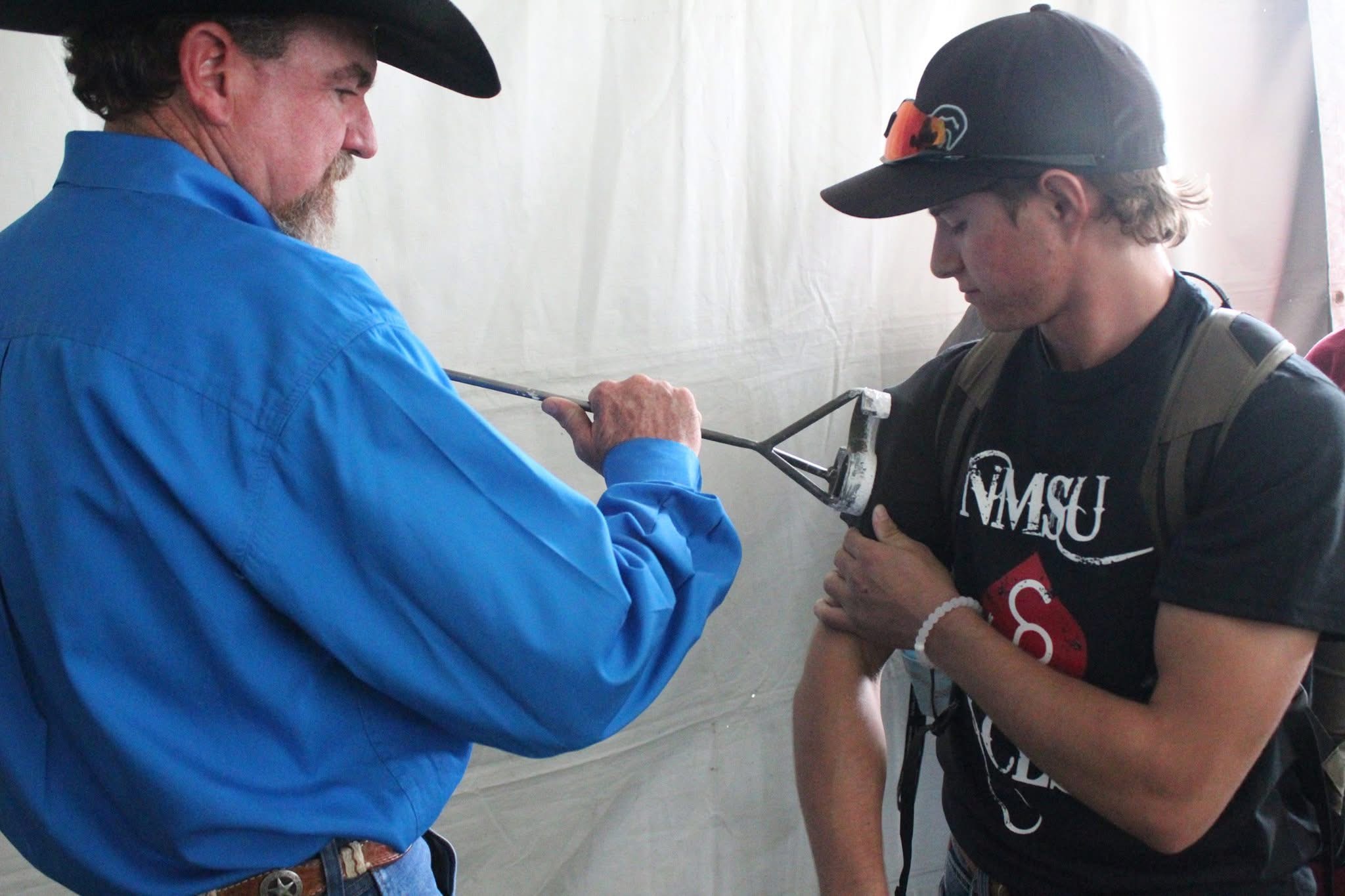 ACES student participating in the branding ceremony
